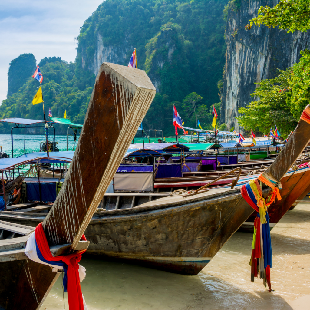 South Thailand Itinerary - Longtail Boats docked on beach in thailand